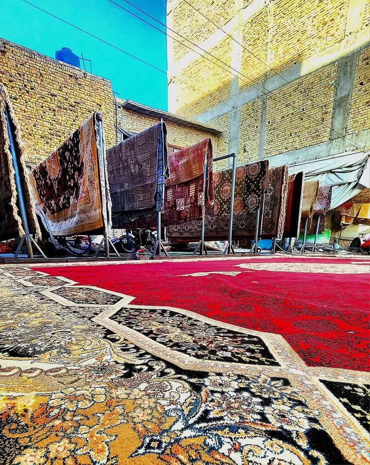 Carpets and rugs hung to dry on racks in the open-air drying yard
