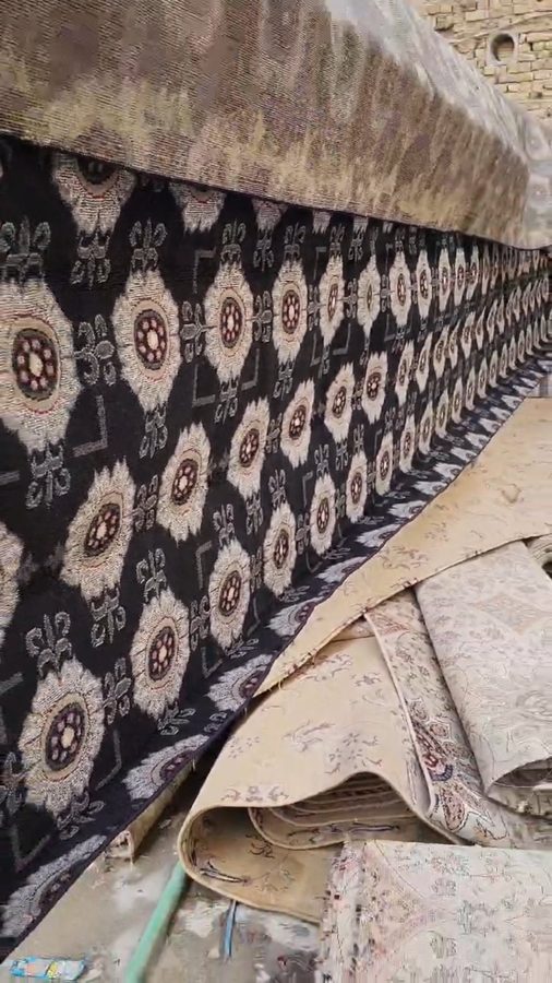 Technician steam-cleaning a carpet with high-pressure sanitisation equipment at Al-Safa